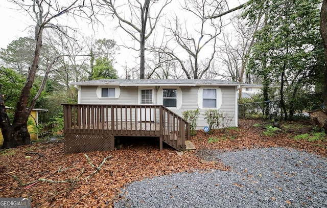 view of front of house featuring a wooden deck and fence