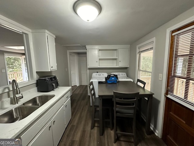 kitchen with white cabinets, dark wood-type flooring, a healthy amount of sunlight, and a sink