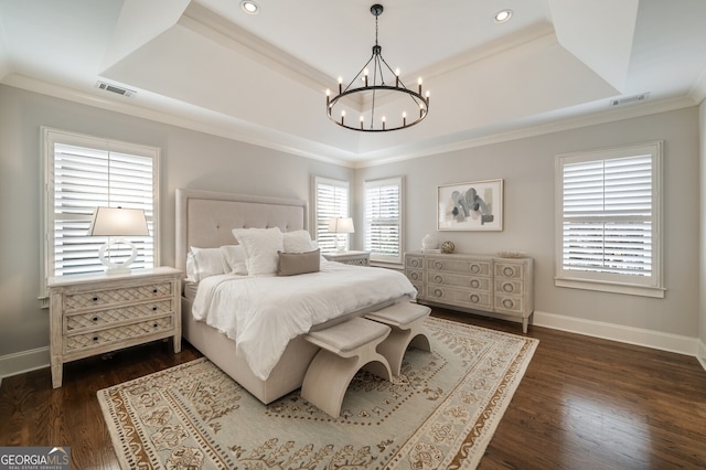 bedroom with visible vents, a raised ceiling, and dark wood-type flooring