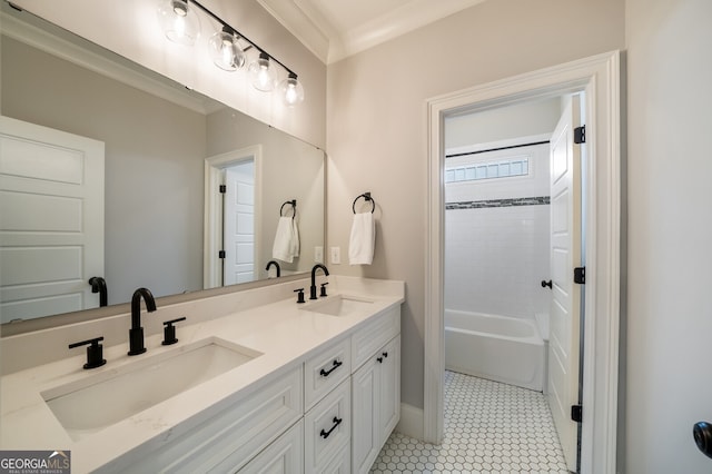 bathroom featuring double vanity, crown molding, and a sink