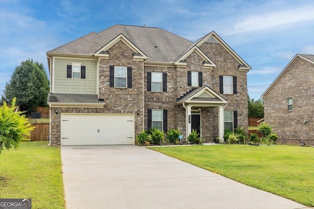 view of front of house featuring brick siding, a front yard, driveway, and fence