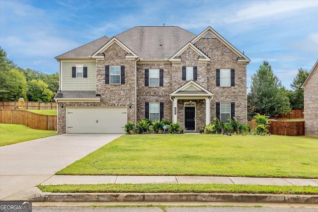 view of front facade with brick siding, a front lawn, fence, concrete driveway, and an attached garage