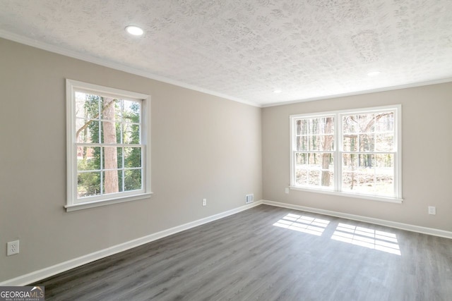 empty room featuring baseboards, a textured ceiling, dark wood finished floors, and crown molding