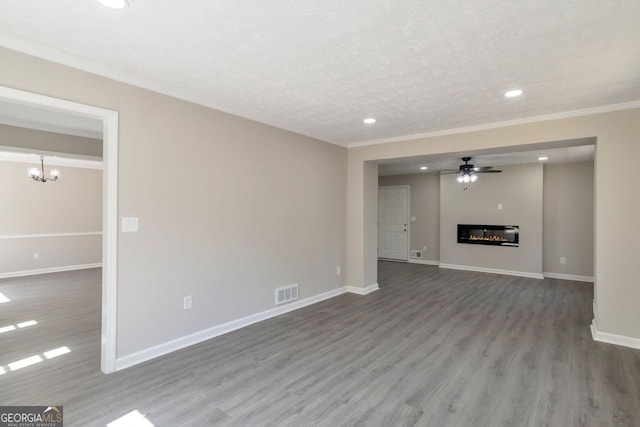 unfurnished living room featuring visible vents, recessed lighting, wood finished floors, and baseboards