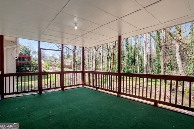 unfurnished sunroom featuring a paneled ceiling