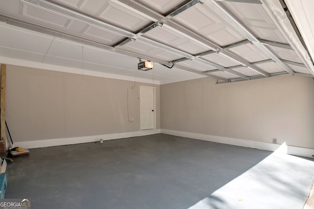 garage featuring a garage door opener and baseboards