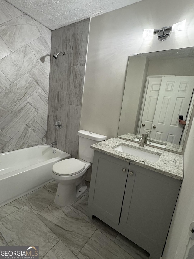 bathroom with shower / washtub combination, toilet, vanity, marble finish floor, and a textured ceiling