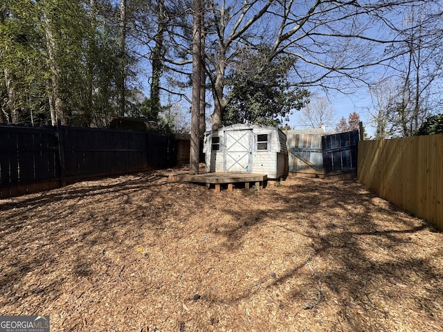 view of yard with an outbuilding, a shed, and a fenced backyard