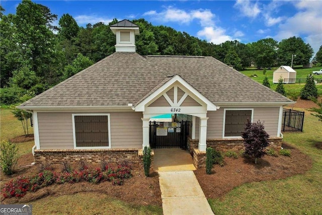 view of front of house with fence, roof with shingles, concrete driveway, a carport, and brick siding