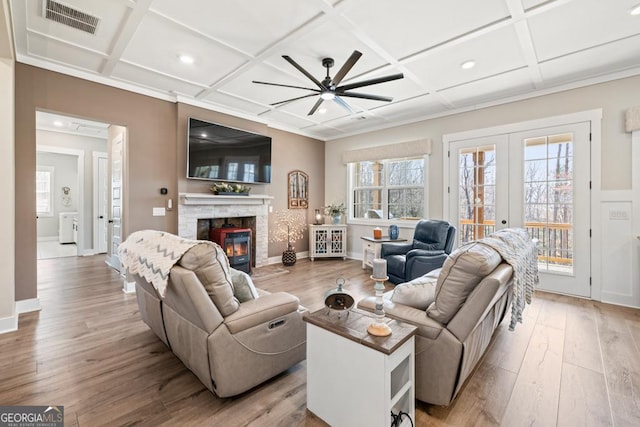 212 Cardiff Ct, Ball Ground, GA 30107 - living room featuring coffered ceiling, a ceiling fan, wood finished floors, a fireplace, and healthy amount of natural light