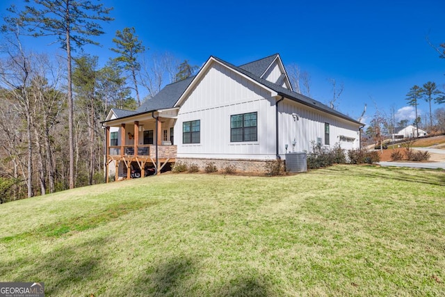 212 Cardiff Ct, Ball Ground, GA 30107 - rear view of house featuring a yard, board and batten siding, central AC, and covered porch