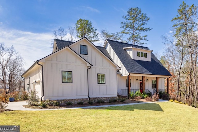 modern farmhouse style home featuring roof with shingles, board and batten siding, and a front lawn