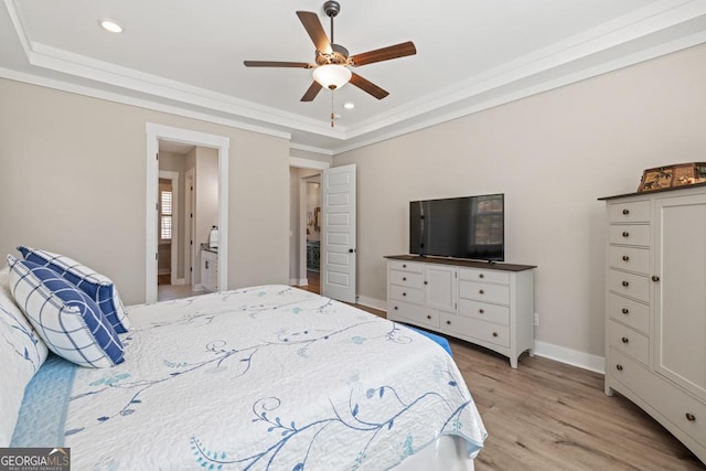 bedroom with a raised ceiling, ornamental molding, recessed lighting, light wood finished floors, and baseboards