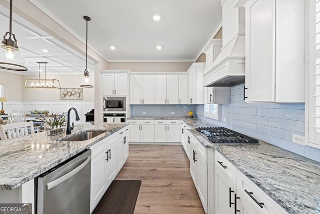 212 Cardiff Ct, Ball Ground, GA 30107 - kitchen featuring appliances with stainless steel finishes, a sink, white cabinets, ornamental molding, and recessed lighting