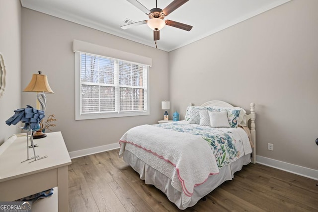 bedroom featuring visible vents, wood finished floors, baseboards, and ceiling fan