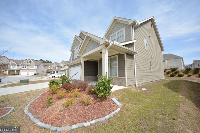 view of front facade featuring brick siding, a front lawn, a residential view, a garage, and driveway