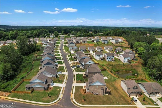 aerial view featuring a forest view and a residential view