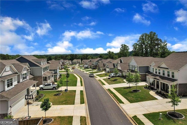 view of street with sidewalks, curbs, and a residential view