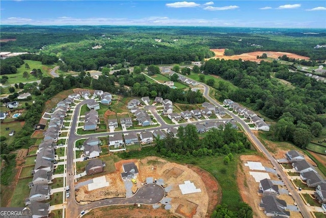 aerial view featuring a residential view and a wooded view