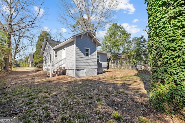 view of side of home featuring entry steps