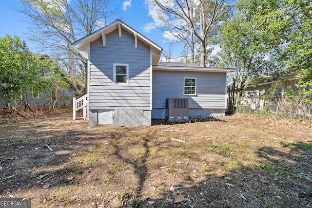 rear view of property with fence