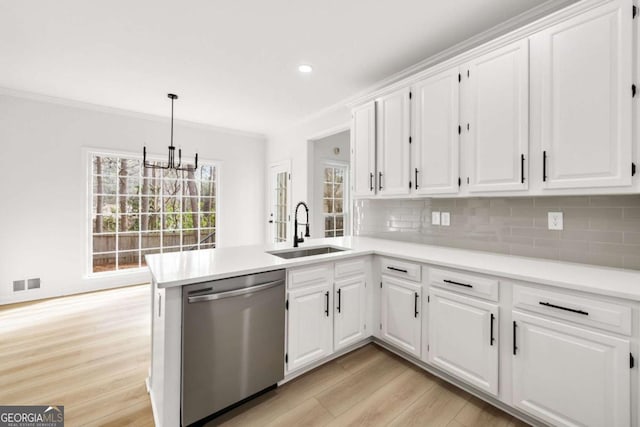 kitchen with visible vents, decorative backsplash, stainless steel dishwasher, white cabinets, and a sink