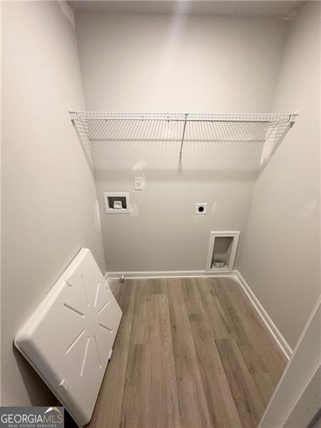 laundry room featuring baseboards, laundry area, hookup for a washing machine, wood finished floors, and hookup for an electric dryer