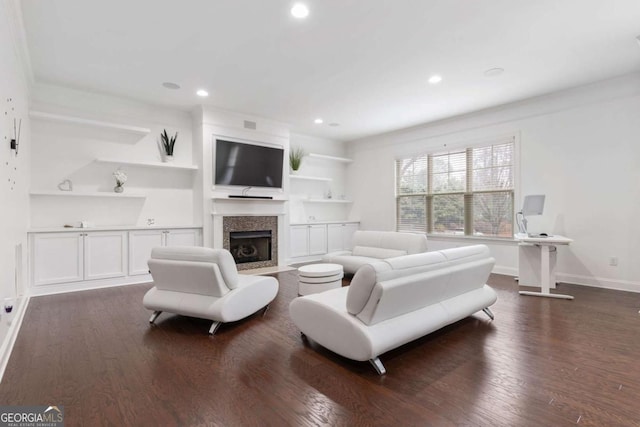 living room with recessed lighting, baseboards, dark wood-style floors, and a fireplace with flush hearth