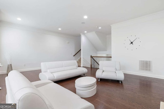 living area with recessed lighting, wood finished floors, visible vents, and baseboards