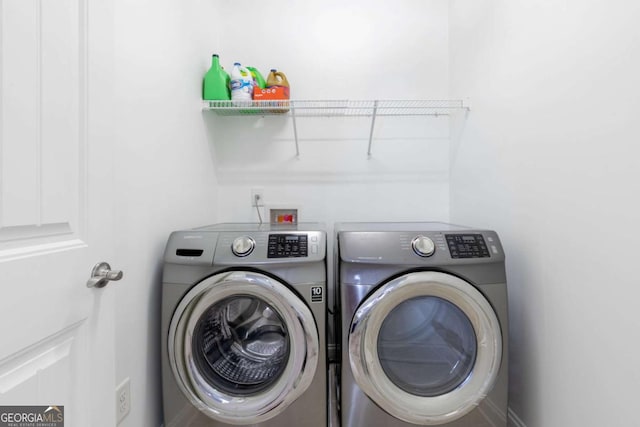 clothes washing area with washer and dryer and laundry area