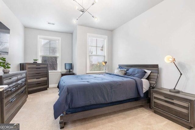 bedroom with light carpet, visible vents, and baseboards