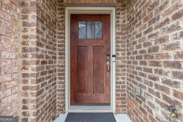 entrance to property with brick siding