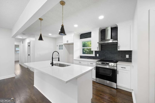 kitchen with an island with sink, a sink, tasteful backsplash, stainless steel range with electric cooktop, and wall chimney range hood