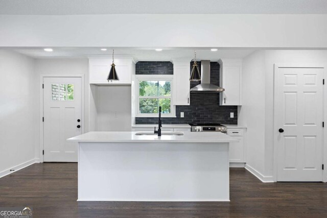 kitchen with a sink, stainless steel electric range, white cabinetry, wall chimney exhaust hood, and dark wood-style flooring