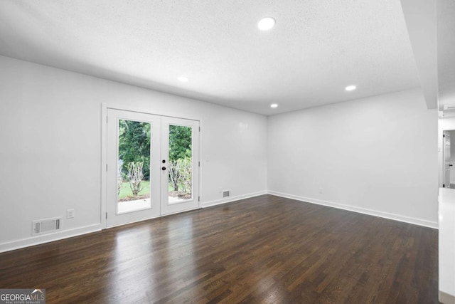 unfurnished room with dark wood finished floors, visible vents, recessed lighting, and french doors