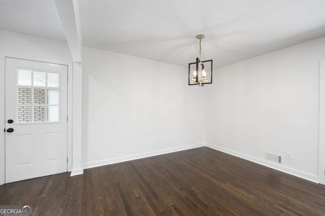 unfurnished dining area with visible vents, baseboards, dark wood-type flooring, and a chandelier