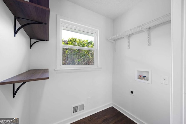 laundry room featuring electric dryer hookup, dark wood finished floors, baseboards, hookup for a washing machine, and laundry area