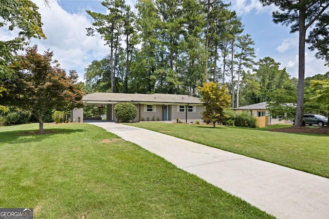 ranch-style house featuring an attached carport, driveway, and a front yard