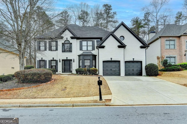 view of front of house featuring concrete driveway and a garage