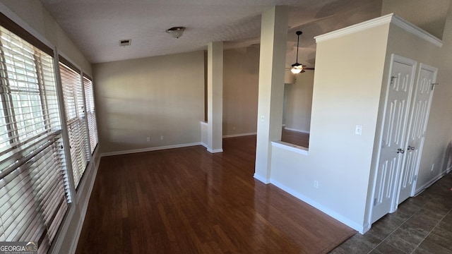 spare room with wood finished floors, baseboards, visible vents, and ceiling fan