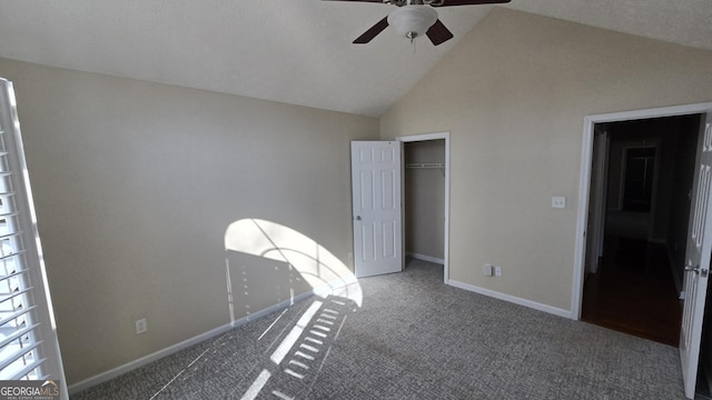 unfurnished bedroom featuring a ceiling fan, carpet, baseboards, high vaulted ceiling, and a closet