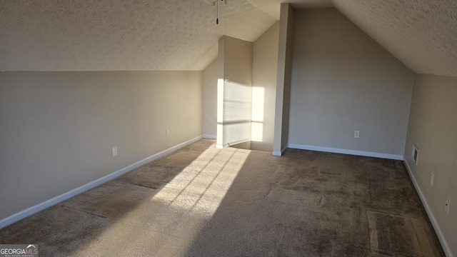 additional living space with baseboards, visible vents, carpet floors, lofted ceiling, and a textured ceiling