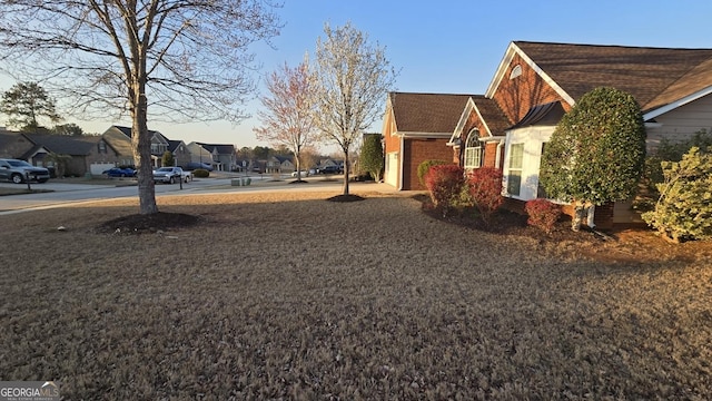 view of home's exterior with a residential view and brick siding