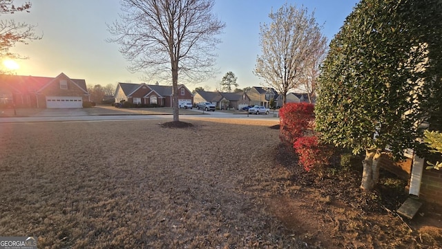 yard at dusk with a residential view