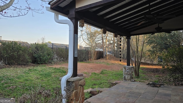 view of yard with a patio area, a ceiling fan, and a fenced backyard