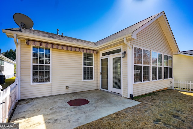 back of property with a patio area and fence