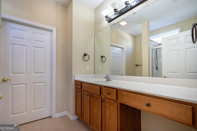 full bath with vanity, tile patterned floors, a shower, and baseboards