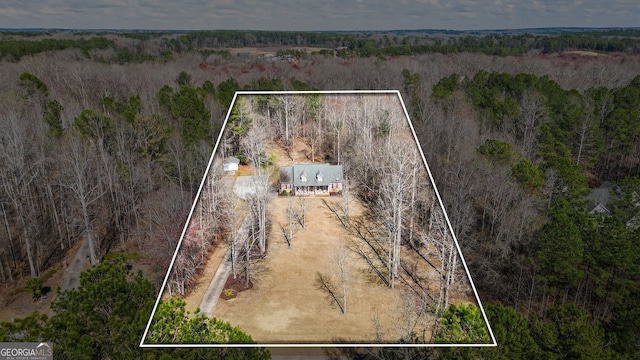 birds eye view of property featuring a view of trees