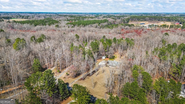 birds eye view of property with a view of trees