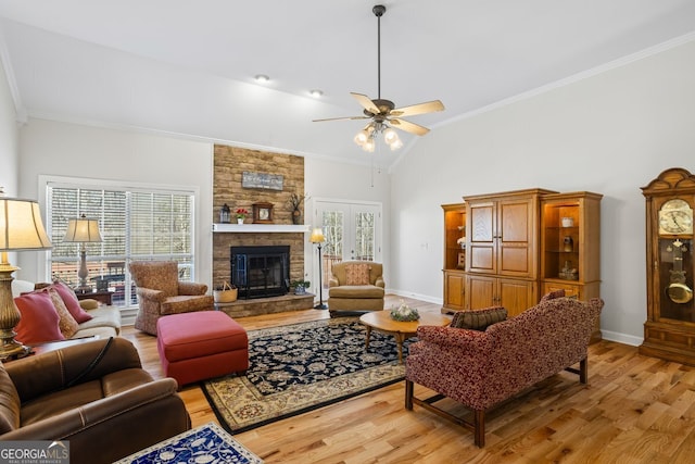 living area featuring a wealth of natural light, light wood-type flooring, and ornamental molding